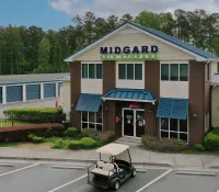 a building with a lawn mower in front of it