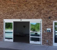 a brick building with glass doors