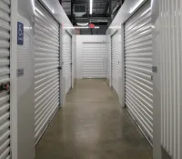 a long hallway with white lockers