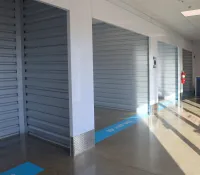 a room with a tv and a wall of lockers