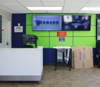 a room with a green board and white tables and a cart