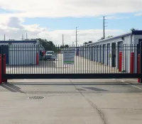 a road with a fence and cars on it