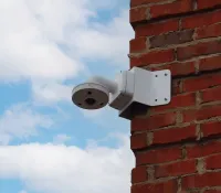 a camera on a brick wall