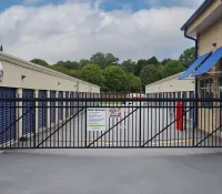 a black gate with a sign on it