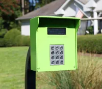 a green mailbox in a yard