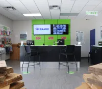 a room with a table chairs and shelves with signs on the wall