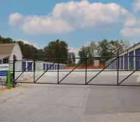 a fenced off area with a building in the background