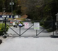 a road with a fence and signs