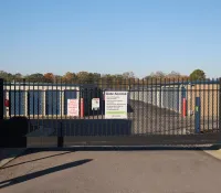 a black fence with a sign on it