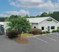 a white building with a parking lot