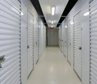 a long hallway with white lockers