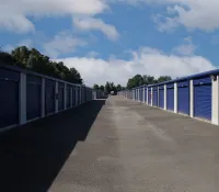 a row of metal fenced in metal containers