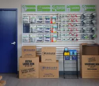 a store with boxes and a blue door