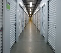 a long hallway with white lockers