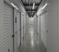 a long hallway with white lockers