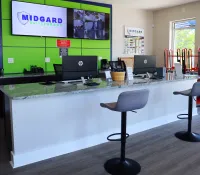 a desk with chairs and computers