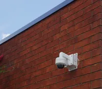 a camera on a brick wall