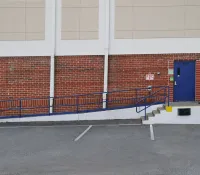 a brick wall with a blue railing