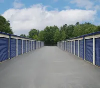 a row of blue and white metal fenced in doors