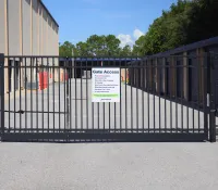 a black gate with a sign on it