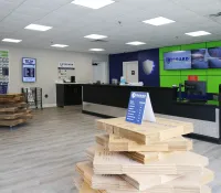 Midgard Self Storage lobby with counter, packaging supplies, and security monitors on a green and blue wall.