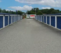 a row of blue and white metal fenced in doors