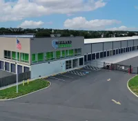 Modern Medgard Self Storage facility with multiple storage units and office building under blue sky