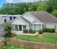 a house with a lawn and a fence in front of it