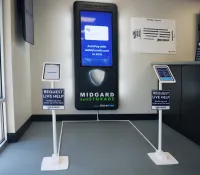 Interactive Midgard Self Storage kiosk with auto-pay and live help iPads in a bright lobby corner.