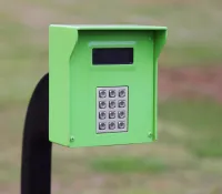 a green phone on a black stand