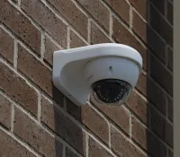 a white light bulb on a brick wall