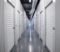 a long hallway with white lockers