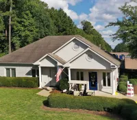 a house with a lawn and a flag in the front