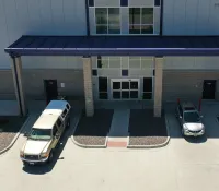 a bus and a car parked outside a building