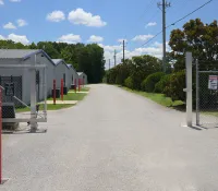 a road with a fence and a gate on the side