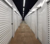 a long hallway with rows of white lockers