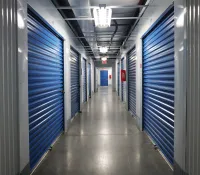 a long hallway with blue lockers