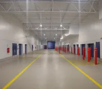 a long hallway with red and blue doors