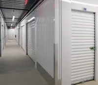 a long hallway with white lockers