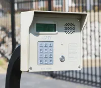 a white rectangular object with buttons and a screen on a metal surface