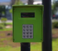 a green and black parking meter