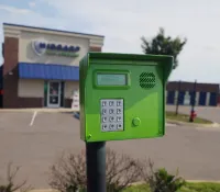 a green mailbox on a street