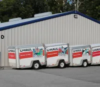 a group of semi trucks parked outside a building