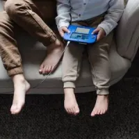 kids on couch barefoot playing game