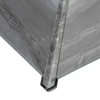 Close-up of a corner edge of grey marble slabs joined with a metal corner protector on a white background