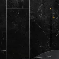 Close-up of black marble tiles with white veins and subtle golden highlights in a polished finish