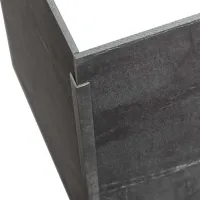 Close-up of a metal corner joint with two dark gray steel panels connected by a metal bracket.