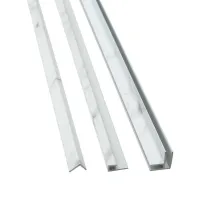 Three white marble-patterned plastic trim pieces with different cross-sectional shapes on a white background