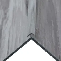 Close-up of a corner joint of two gray stone or concrete slabs with precise paver edging in a modern installation.