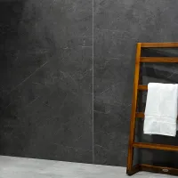 Wooden towel rack with a white towel against a dark gray textured wall and light gray floor tiles